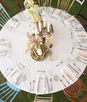 Overhead view of a round wedding table set on the lawn at Akasha Farm